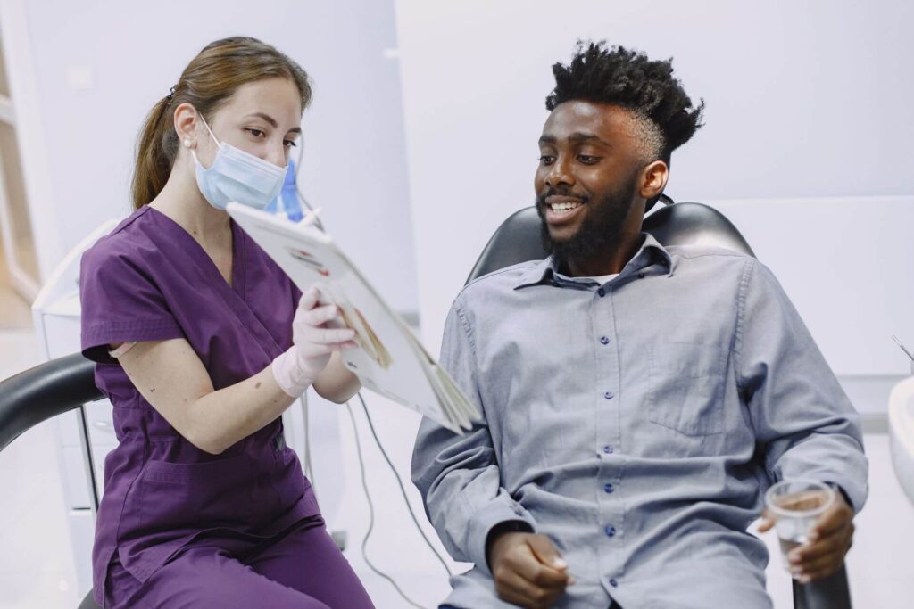 Dentist discussing professional teeth whitening treatment with patient in Los Algodones, Mexico